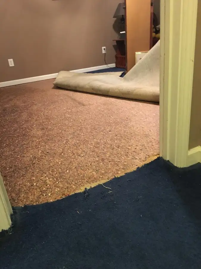 Carpet pad removal revealing water damage during Water Mitigation Services in Cedar Hills